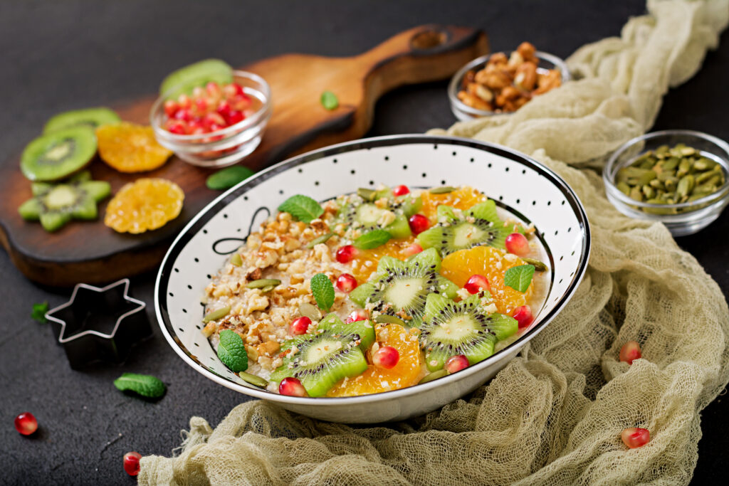 Home tasty healthy oatmeal porridge with fruit berry nuts healthy breakfast fitness food proper nutrition