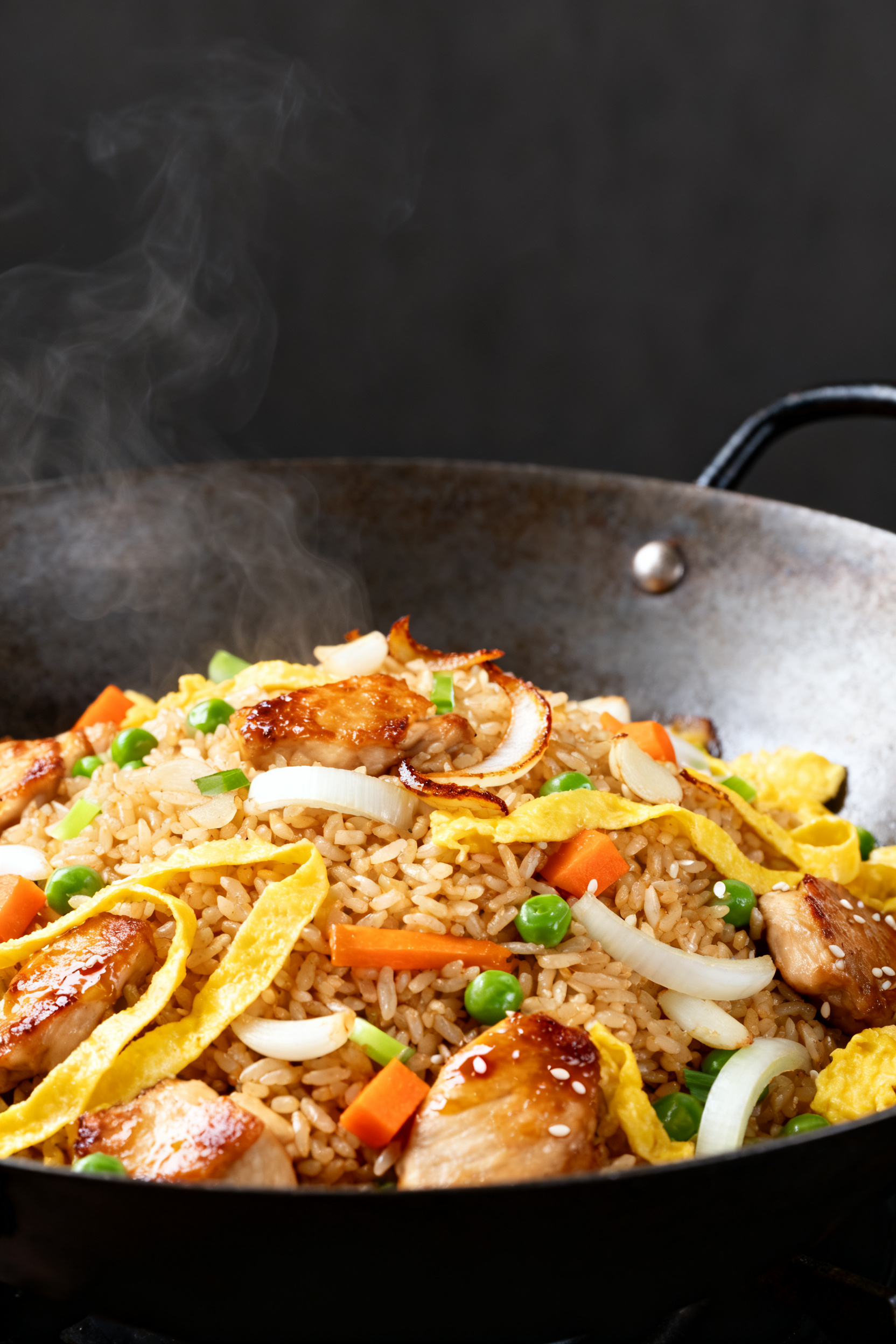Leftover Chicken Recipes Better Than Takeout - Fast, Flavorful, and Budget-Friendly Cooking process close-up: Chicken Fried Rice sizzling in a carbon-steel wok, rice pressed into the p