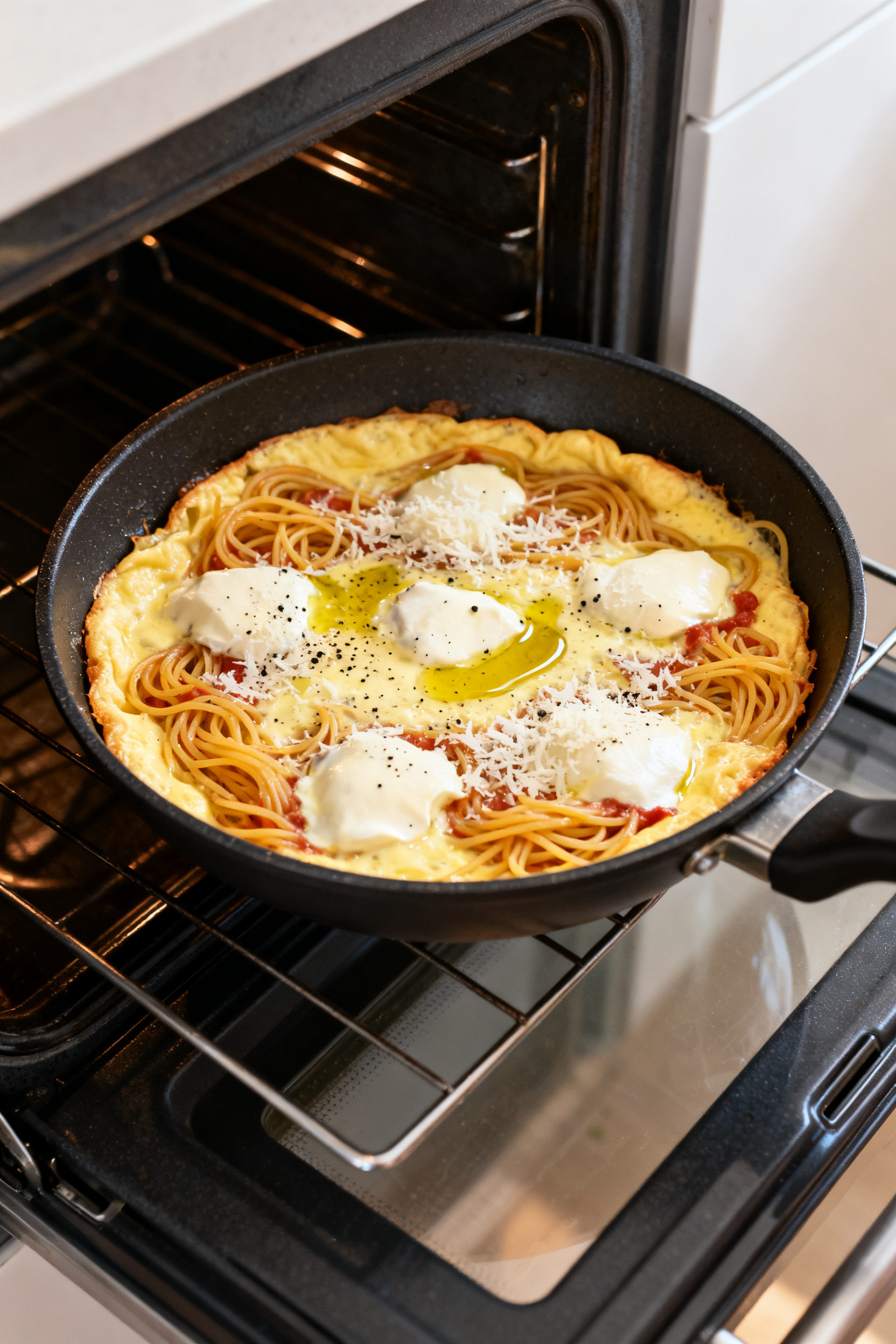 Pasta Night Just Got More Interesting → "Leftover Spaghetti Ideas — Pasta Night Just Got Better" - Easy Ways to Reinvent Last Night’s Noodles Cooking process: Spaghetti frittata (skillet pie) setting in an oven-safe nonstick pan—surface gen