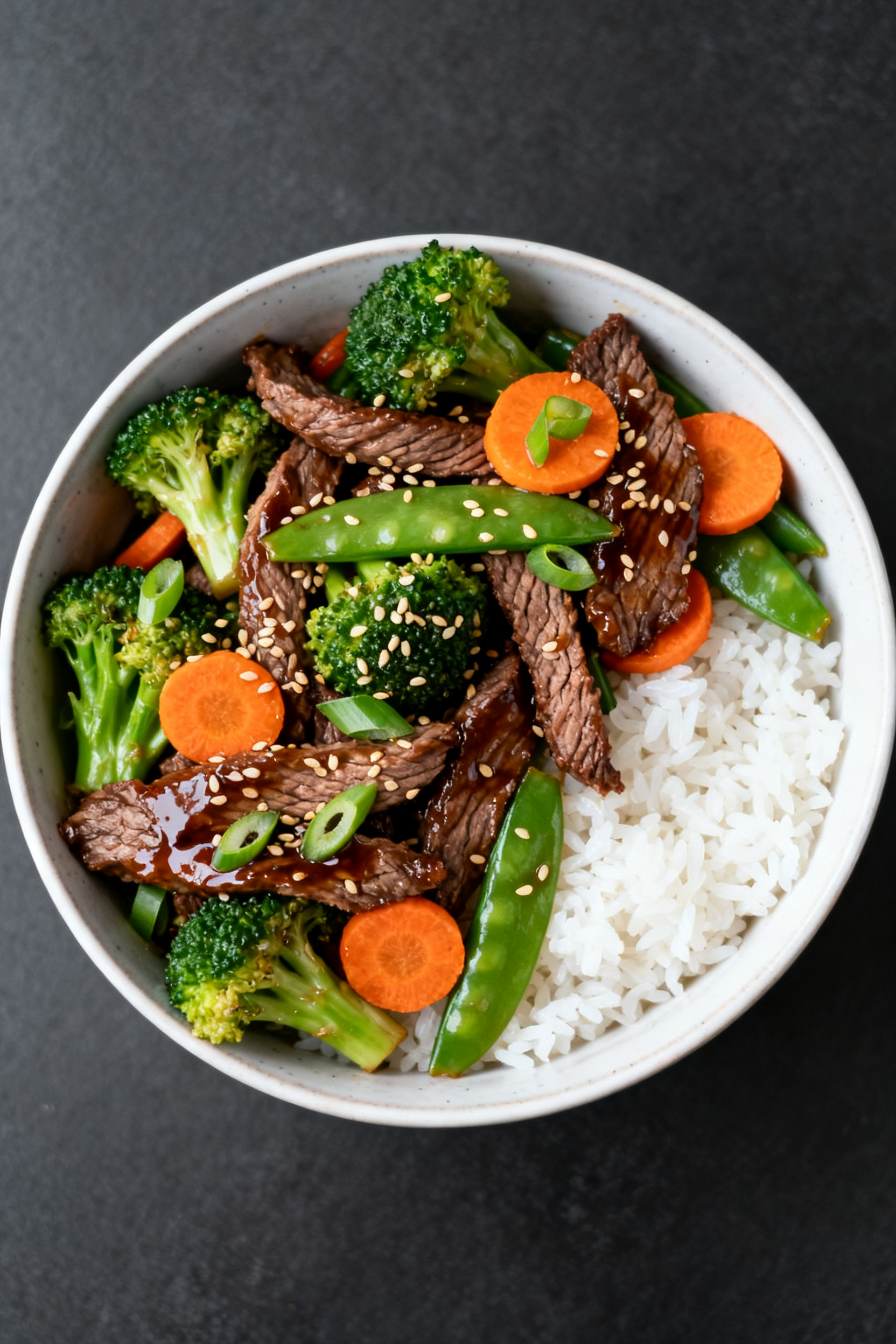 Empty Fridge. Full Dinner Table. → Leftover Roast Beef Recipes — Empty Fridge Full Table Overhead tasty top view: Garlic-soy stir-fry bowl—thin-sliced roast beef folded into vibrant brocc