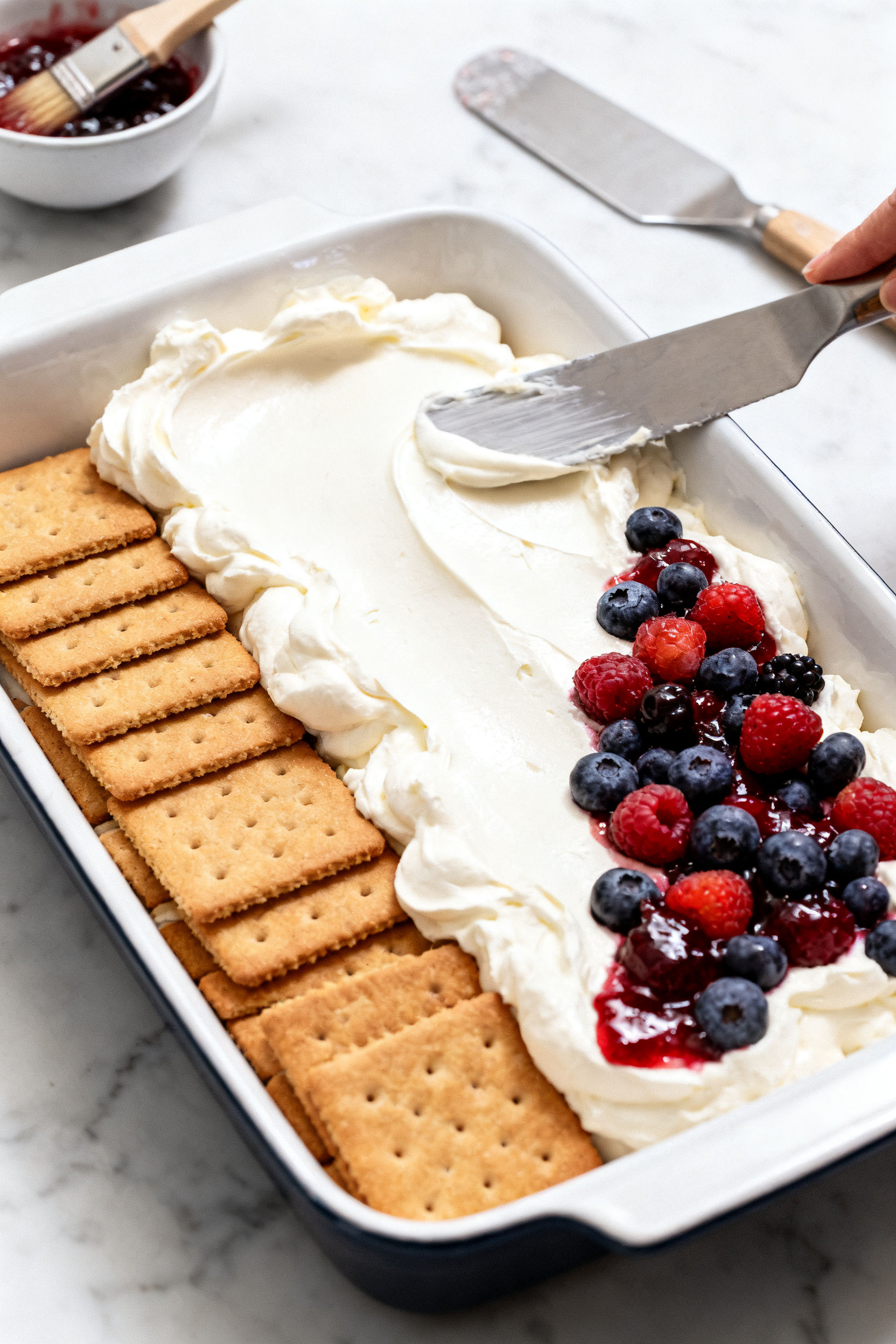 Process shot (prepared stage, no raw ingredients): Mid-assembly scene focusing on the “add cream a