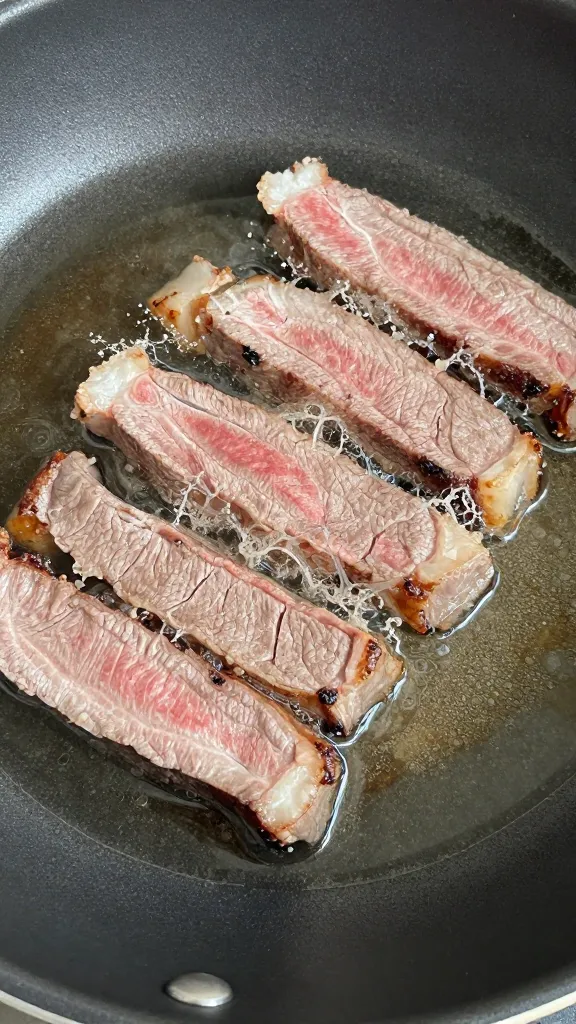 cold steak slices reheated in skillet with splash of broth