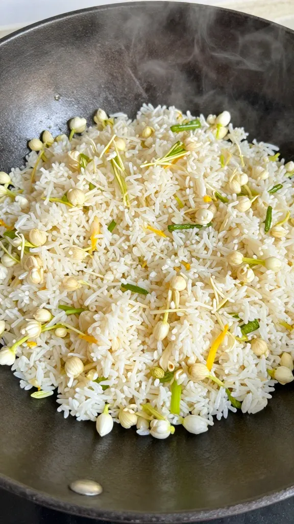 Day-old jasmine rice stir-fry in smoking cast-iron wok
