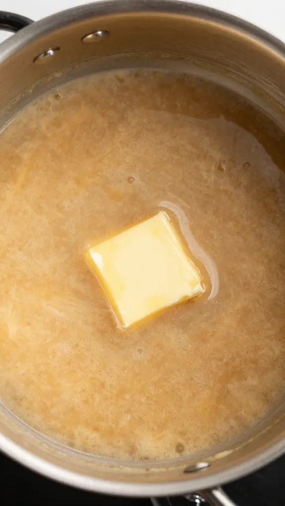 Prime rib gravy in small saucepan, butter melting