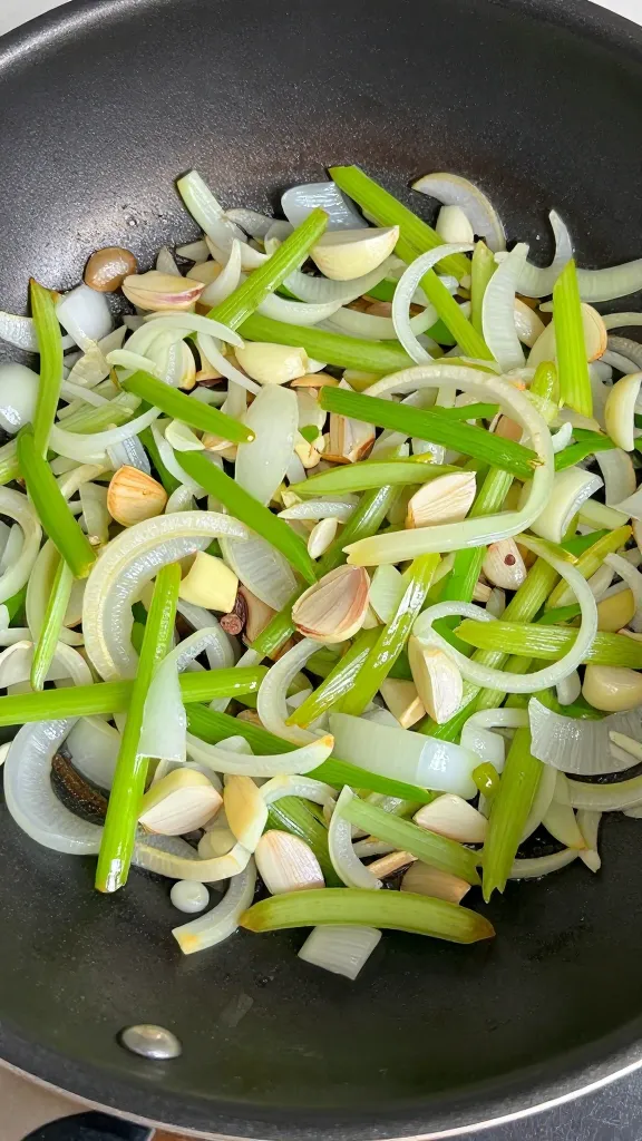 sautéed aromatics in skillet, onions garlic celery glistening