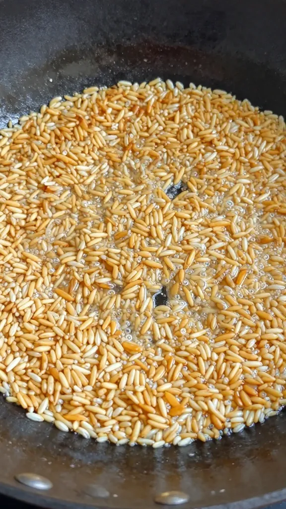 Individual rice grains sizzling in wok close-up