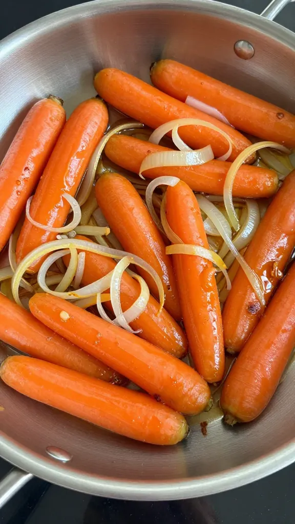 High-heat sautéed carrots and onions in stainless pan