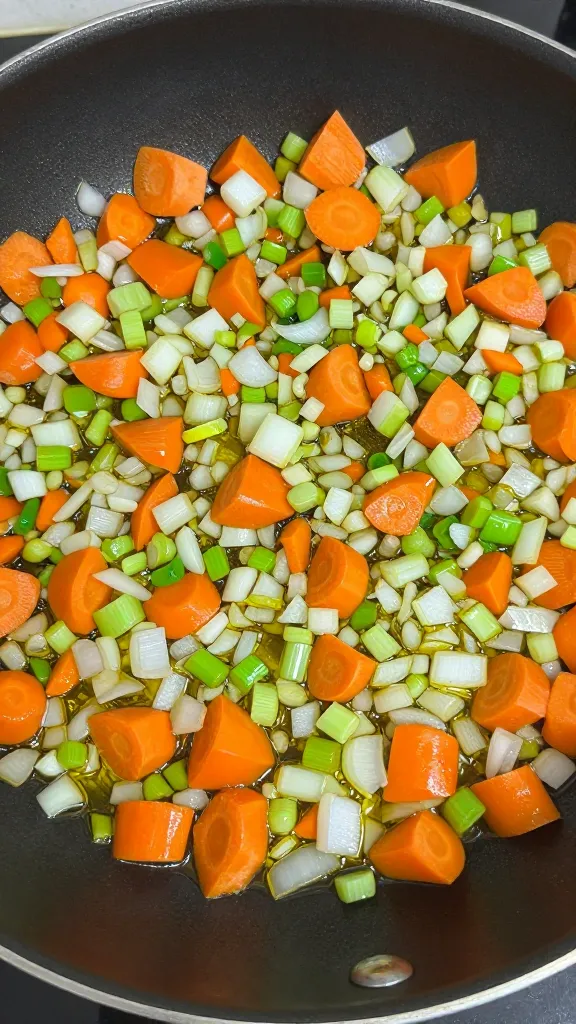 diced onion carrot celery in skillet, olive oil sheen